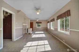 View from dining room looking at front door, hallway to 2nd living room on left, plenty of light!