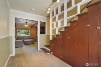 Hallway leading to upstairs, and 2nd living room. More storage under the stairs!