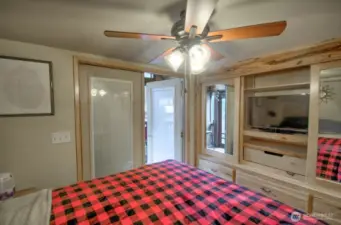 PRIMARY BEDROOM, FRENCH DOORS OPEN TO A  SCREENED IN BACK PORCH