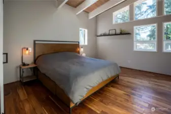 Primary bedroom with vaulted ceilings