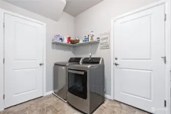 Utility room with garage access and under stair storage.