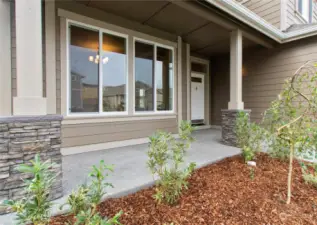 Similar home, not actual. Covered front porch with stone accents.