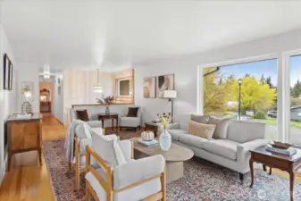 Large windows fill the living room with natural light.