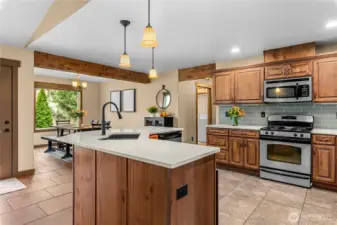 Modern kitchen with center island, dual sink, and stainless appliances.