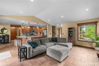 Inviting living room with stone fireplace, natural light, and open layout.