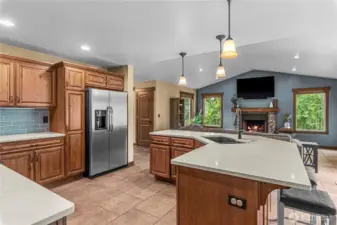 Kitchen with expansive island, dual sink, and open view to living room.