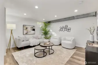 The downstairs living room. Nice sized space here for gatherings or watching tv.