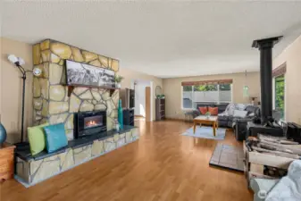 This angle highlights the seamless flow across the main living space—ideal for gathering or creating distinct areas for relaxing, entertaining, or work-from-home setups. Durable laminate flooring connects the entire room for a cohesive feel.