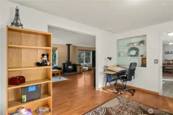 Open to the main living area, this flexible room connects seamlessly with the home’s central spaces while maintaining its own privacy. Built-in shelving adds function and character, making it perfect for creative use — from a homework zone or art studio to a cozy den for multigenerational living needs.