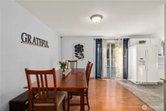 Large eat-in dining area with direct access to the deck via sliding doors—great flow for everyday meals and larger gatherings.