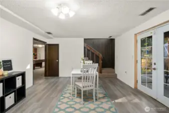 The lower level features a spacious kitchenette and dining area with French doors leading to the backyard patio, offering great natural light and easy indoor–outdoor flow. Updated flooring adds a fresh touch, making this a functional and comfortable space for guests, extended family, or entertaining.