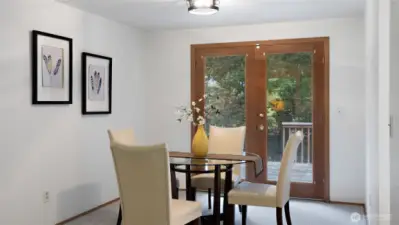 Beautiful French doors open to the back deck, creating an easy flow between indoor and outdoor living. It’s the perfect setup for summer meals, morning coffee, or simply taking in the fresh air.