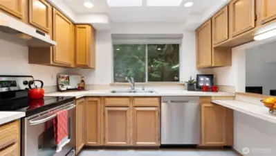 This classic kitchen has such a happy feel, with sunlight pouring in through the huge skylight above. Newer stainless steel appliances keep things fresh and functional, and the bright, cheerful vibe makes it a space you’ll actually love spending time in.