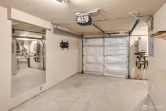 Large garage space w/ storage tucked around the corner