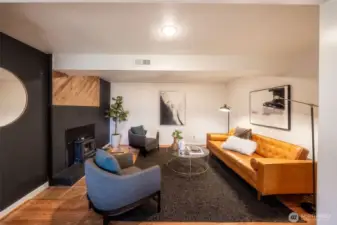 Family room with cozy wood burning fireplace insert.