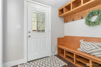 Quaint back door entry with built-in coat rack + bench with organizer