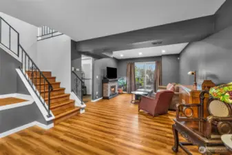 Inviting downstairs family room with decorative paint accents, custom cut outs details, wood floors and added charm thoughout.