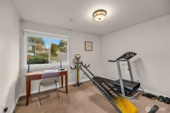 One of the three bedrooms used as a work out room or office.