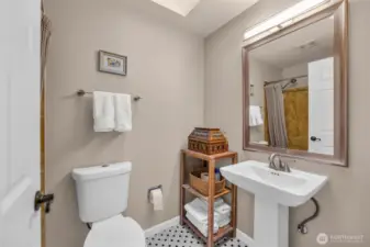 The full bath off the hallway has new tile flooring, skylight and more