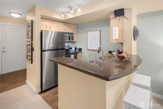 Welcome in! The kitchen’s granite counters and stainless appliances make an elegant first impression—plus there’s plenty of prep space for your inner chef.