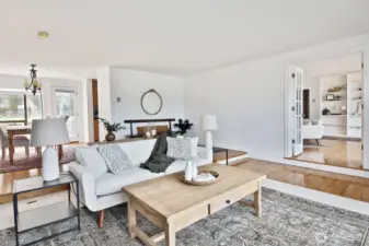 And another perspective of the living room & family room. The kitchen is through the doorway off of the dining room. Door in the Dining Room leads to your back patio. Let's go check out the family room. Gorgeous wood floors!
