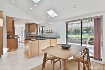 There is plenty of room at the counter for a few bar stools. Glass doors open to your pristine backyard patio. Let's step outside for a quick peek......
