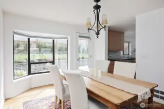 Dining room has a glass door to your backyard patio. Your back is to the stairs that lead to the upper primary and to the two-car garage.