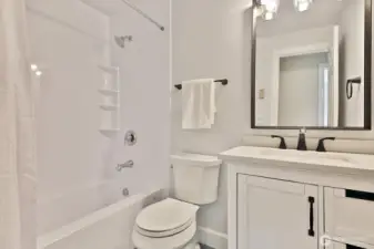 Remodeled full guest bath. You can see the doorway to the 3rd bedroom reflected in the mirror.