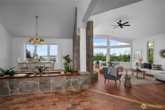Beautifully open and welcoming, this living and dining space blends rustic, yet elegant charm and natural light with breathtaking views of the water.
