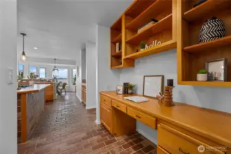 Thoughtfully integrated built-in desk and shelving create a versatile workspace just steps from the heart of the home.