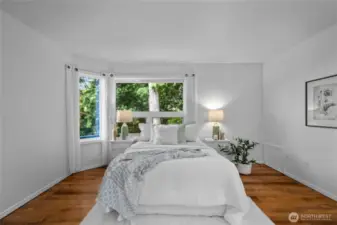 Wake up to treetop views and soft morning light in this serene primary suite- where nature is just outside your window and calm meets comfort.