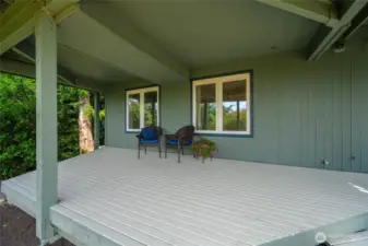 Tucked beneath the upper deck, this covered patio offers a peaceful retreat for the lower-level living area.