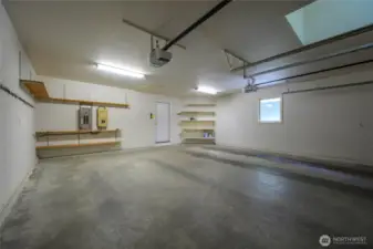 Spacious 2-car garage with ample storage and built-in shelving—perfect for tools, gear, or a workshop.