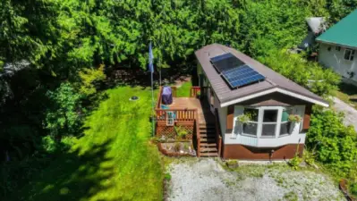 Double lot with cute 728sf unit already in place,  Solar power, off grid community and no restrictions on AirBnB