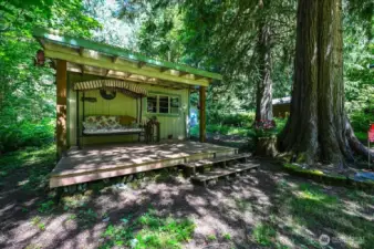 Side of the battery and generator shed with a cute covered deck area.