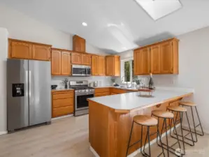 Featuring stainless steel appliances, tons of cabinet storage, a pantry with a brand-new door, and a breakfast bar perfect for casual meals or entertaining.