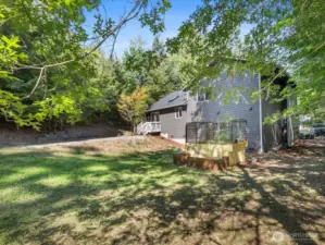 The expansive backyard is fully surrounded by trees, offering unmatched seclusion and a peaceful retreat.