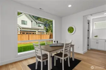 Dining area with large windows bringing in tons of natural light!