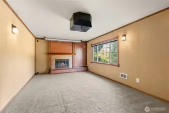 Lower level family room with wood fireplace.