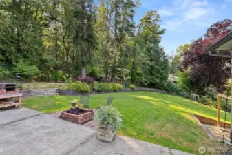Patio with fire pit and brick oven.