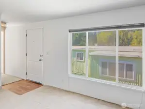 Sunlight pours through the large window, filling the living room with warmth.