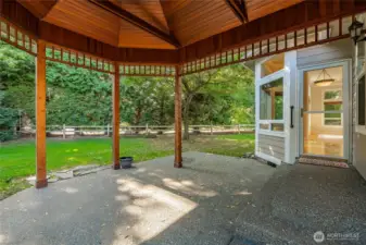 Large covered patio. Door leads into the dining area. Door to the Primary Bedroom to the right.