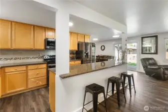 Beautiful open kitchen with stainless steel appliances and granite counters