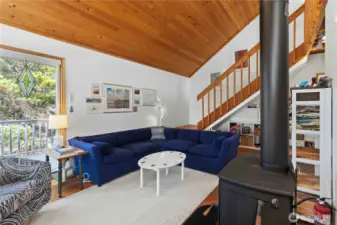 Skylights and expansive windows bring in natural light and solar warmth, enhancing the connection to nature.