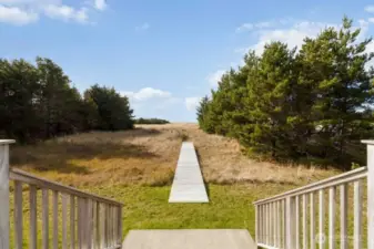 Private boardwalk crosses the dunes, keeping your feet dry as you follow your own path to the sand.