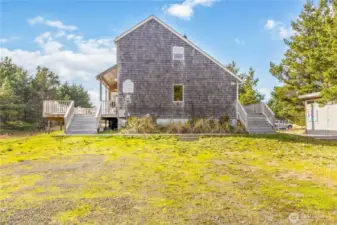 Low-maintenance coastal landscaping and a convenient 50-amp electric car charger right out front.
