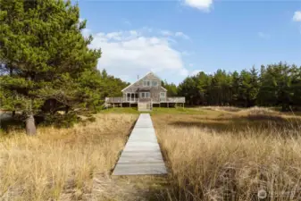 Native shore pines and rolling dunes create a tranquil and protected coastal environment.