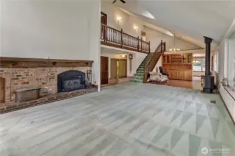Living Room with Wood Burning Fireplace Insert Off Dining Room