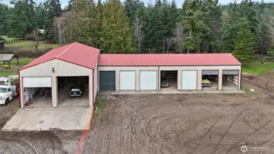 Nine Bay Corrugated Steel Garage With Electricity And Lighting On Concrete Pad