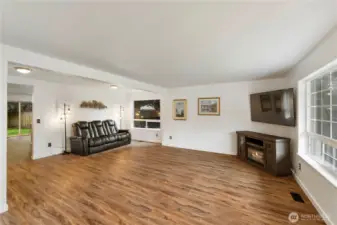 View of living dining room as you head to second family room and kitchen at back of home